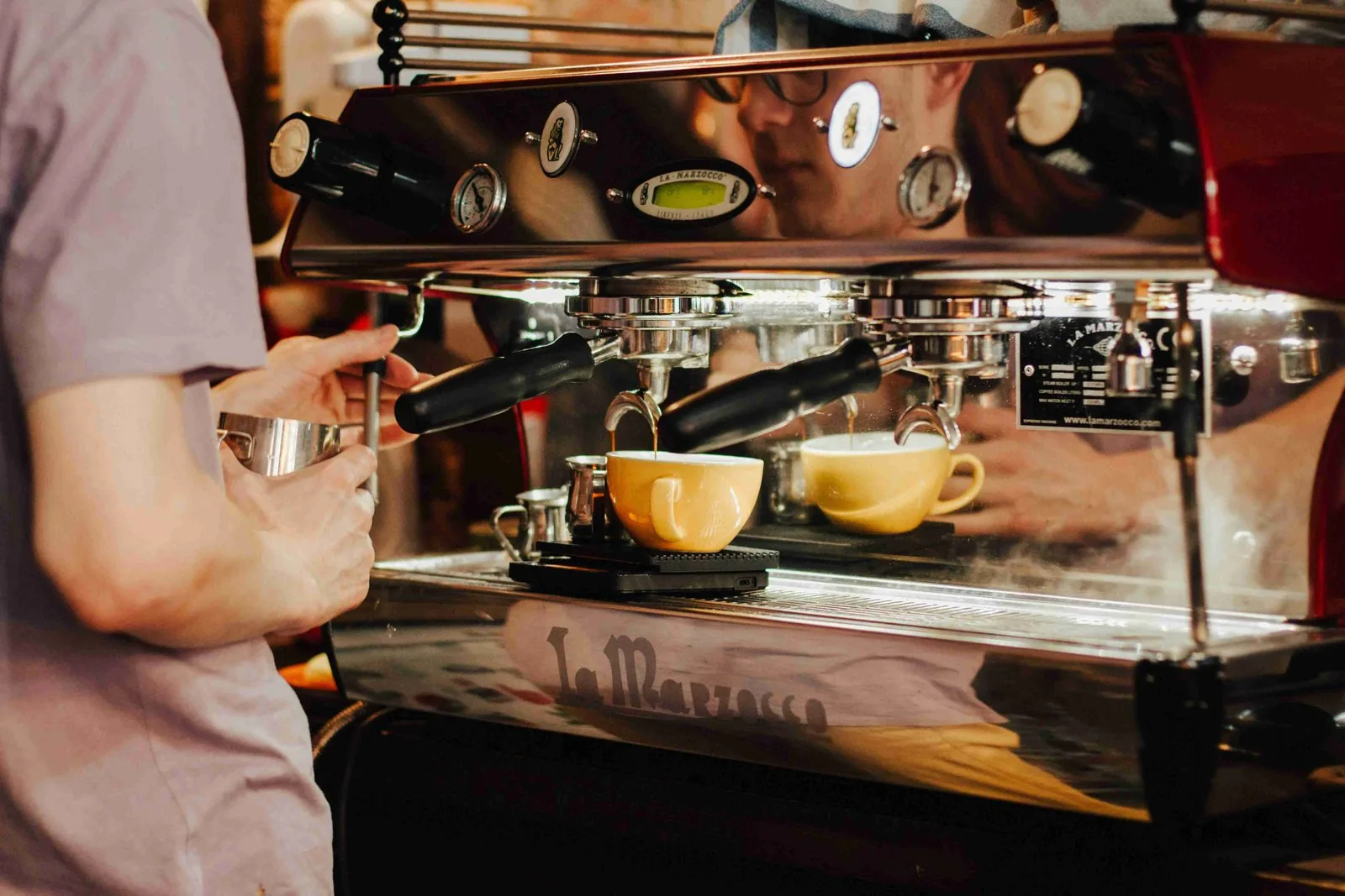 Barista preparing a latte in the in-house café at GRIPswich Bouldering, Ipswich